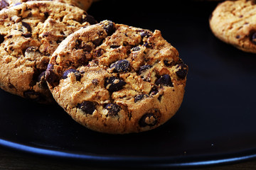 Chocolate cookies on wooden table. Chocolate chip cookies shot