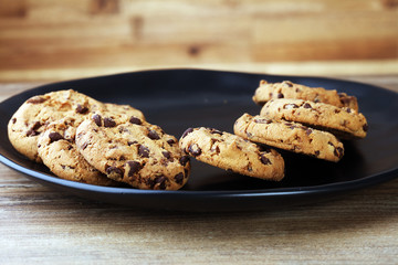 Chocolate cookies on wooden table. Chocolate chip cookies shot
