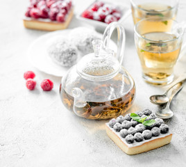 Breakfast with a variety of cakes and tea. 