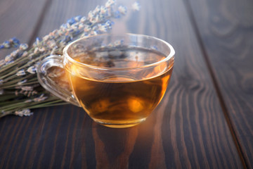 Cup of lavender tea and lavender flowers.