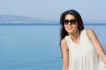 portrait of beautiful happy young  woman on a sea background .Summer holiday