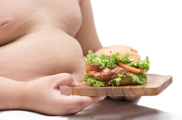 pork hamburger on  wood plate and obese boy background