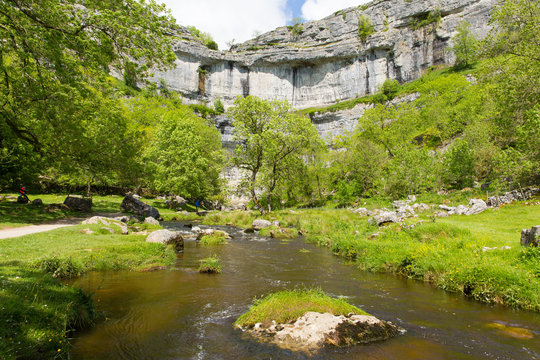 Malham Cove with the stream at the bottom of the rocks Yorkshire Dales National Park UK