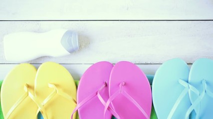 Bright women's flip flops and beach towel