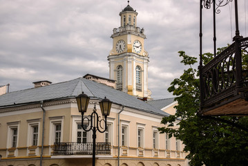 Fototapeta na wymiar Old house and clock tower in Vitebsk. Belarus, June 2017.