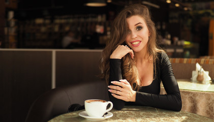 Vintage beautiful woman in restaurant cafe with cup of coffee. Stylish rich slim glamorous lady at vacation. Retro style. France.