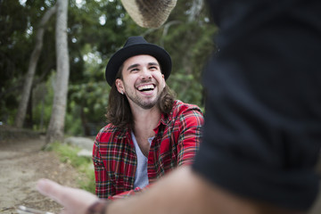 Man looking at male friend while sitting in park