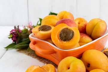 Naklejka na ściany i meble Ripe apricots in a ceramic bowl on a white background.