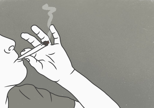 Cropped image of man smoking marijuana against gray background