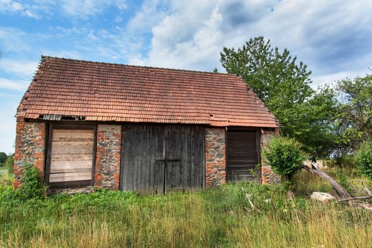 An old abandoned barn in the countryside in the Czech Republic. Summer day at the farm.