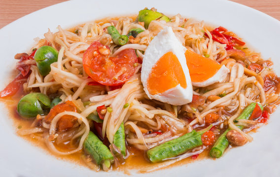 Papaya salad on top with salted egg "Somtum" in Thai, Famous Thai food.