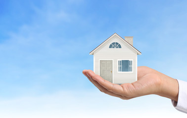 Mortgage concept by house from  hand