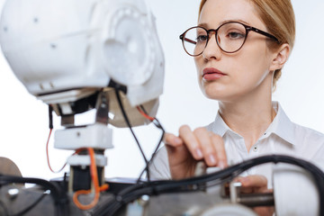 Tenanted precise woman fixing the mechanism