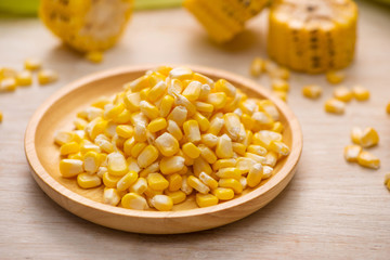Sweet corn seeds on a wooden plate