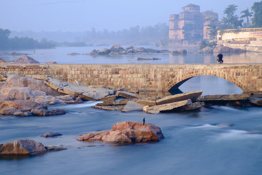 Photographer taking picture of the temples on the bank of Betwa river, Orchha. Long exposure.