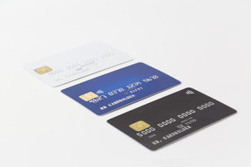 Three credit cards in a row on white background