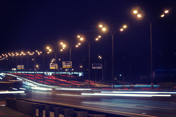 Fototapeta na wymiar Night highway with light trails, speed traffic