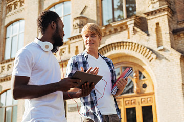 Intelligent hardworking man discussing project with his friend