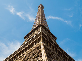 The Eiffel tower in Paris, view from below against the sky, directly vertically.
