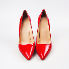 female red high-heeled shoes over white