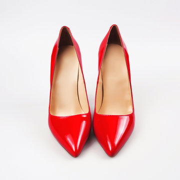 female red high-heeled shoes over white