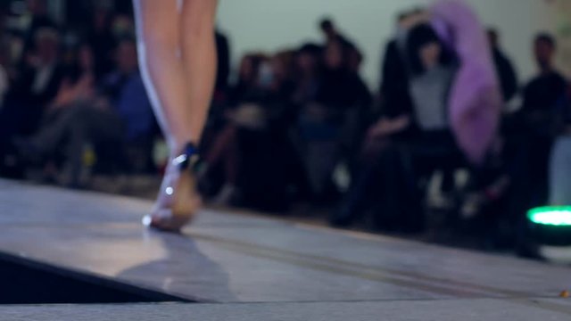 model on presentation of female underwear on catwalk, fashion show,sexy girl in lingerie on catwalk in bright lights, model on fashion podium, new of collections of women's clothing, dis-focused,