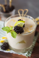Lemon milkshake garnished with blackberry and mint