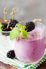 Delicious blackberry smoothie with mint and fresh berries in glass