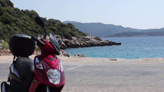 Scooter on the road and beautiful sea view