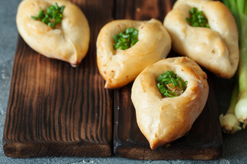 Russian patties rasstegai with fish and fish bouillon