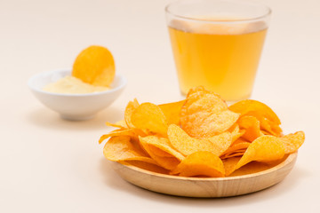 Cheese and onion potato chips with soft drink on table.