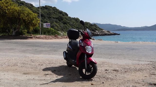Scooter by the side of the road near the seaside 