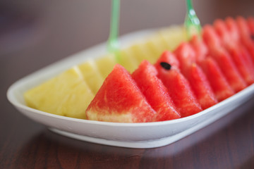 slices of watermelon and pineapple on a table