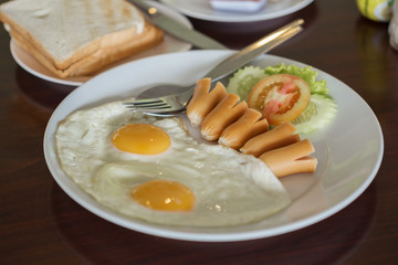 breakfast (fried egg and hot dog and bread)