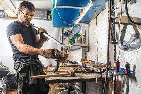 man grinder metal an angle grinder - Powered by Adobe
