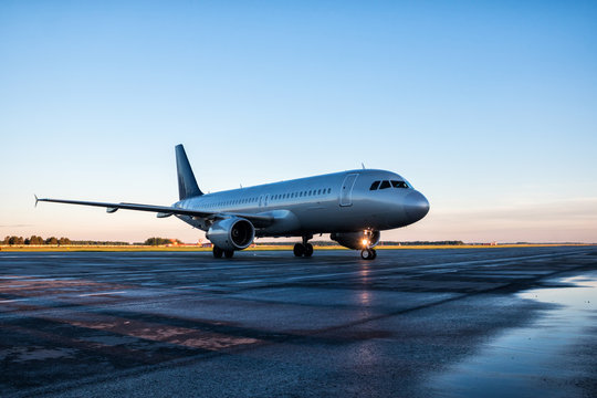 Taxiing Passenger Airplane At The Airport Apron