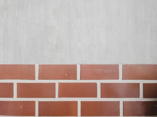 Brick wall with grey cement in background texture 