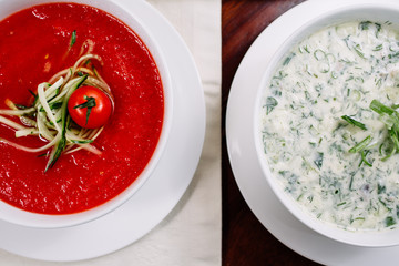 Two soups of okroshka and tomato soup on a wooden table, top view