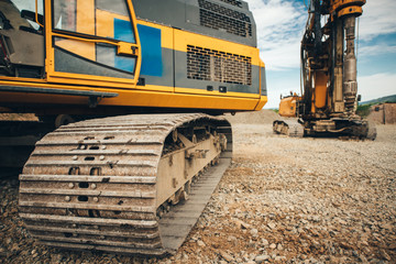 close up details of excavator tracks on construction site