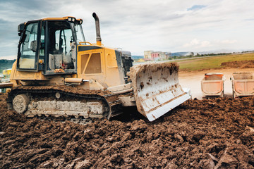 highway construction site development with bulldozer moving earth, soil © aboutmomentsimages