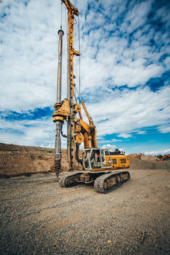 Details of heavy duty machinery on construction site. Detail of highway building with rotary drilling machine