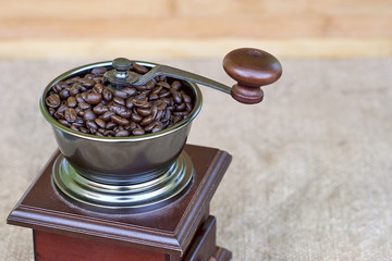 Top part of coffee grinder full of roasted coffee beans