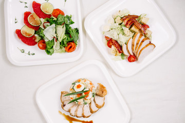 White tablecloth, surrounded by snacks. Variety of dishes. Kitchen, menu, concept of food