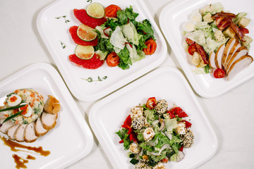 White tablecloth, surrounded by snacks. Variety of dishes. Kitchen, menu, concept of food