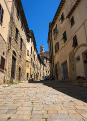 Beautiful narrow street of historic tuscan city Volterra, Italy