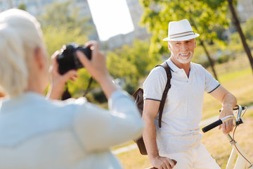 Delighted bearded man posing for his wife