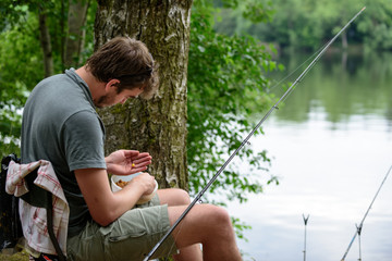Fisherman preparing lure, fishing getaway vacation hobby concept