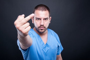 Male medical nurse showing obscene gesture