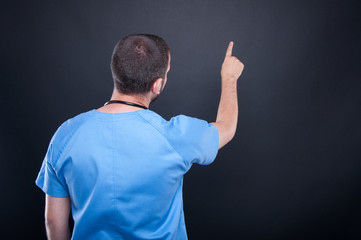 Back view of doctor using invisible touchscreen