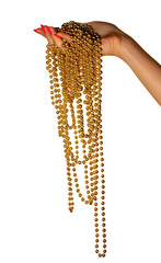 The beautiful female hand with red nails holds a long gold beads. It is isolated on a white background.